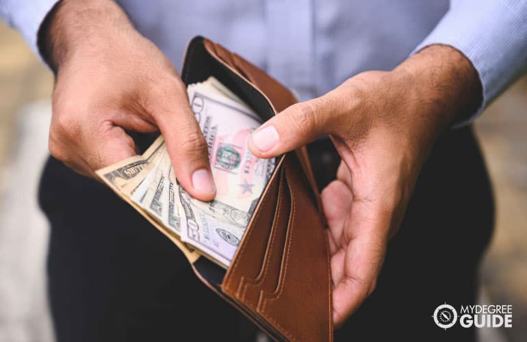 man showing money in his wallet