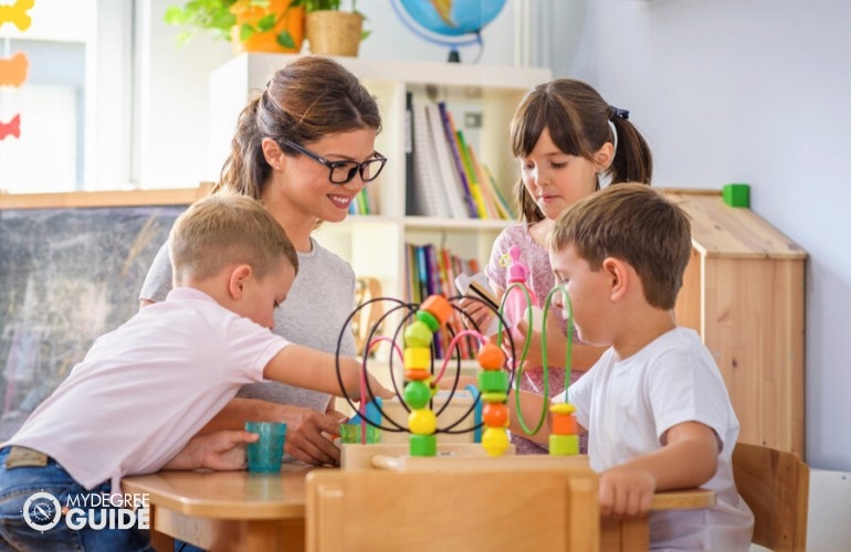 Early Childhood Education Teacher assisting her students in class