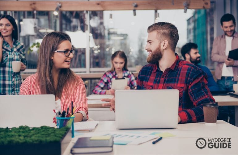 Student with part time job, discussing with colleagues