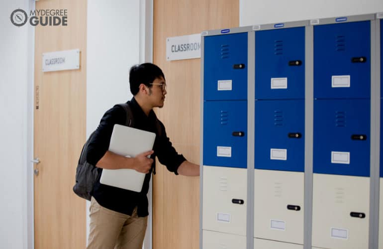 male student walking into a classroom