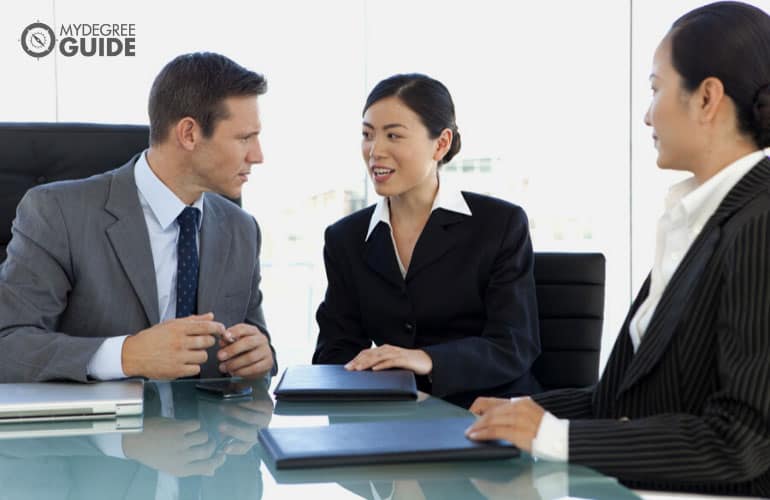 businessman closing a business deal with his asian translator