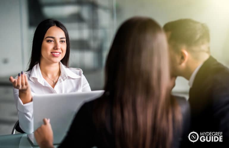 Certified Financial Planner talking to a couple during financial consultation