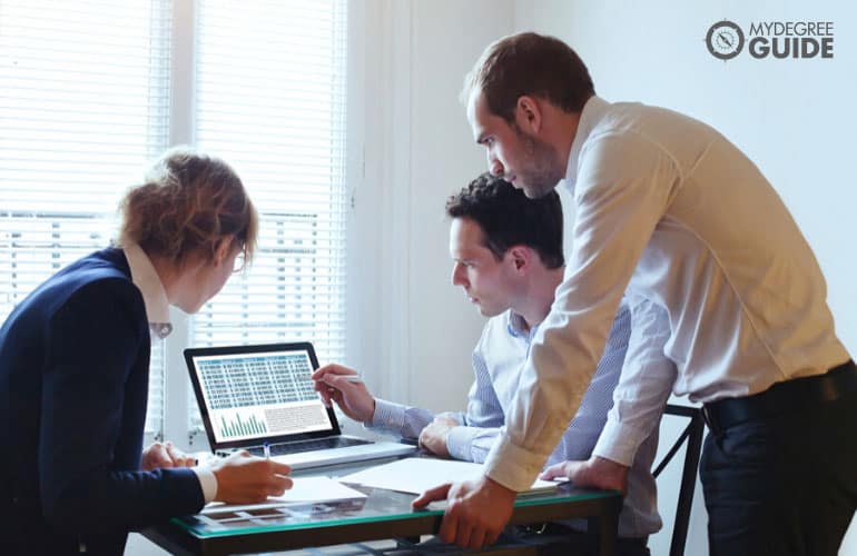 market research analysts looking at data on their laptop