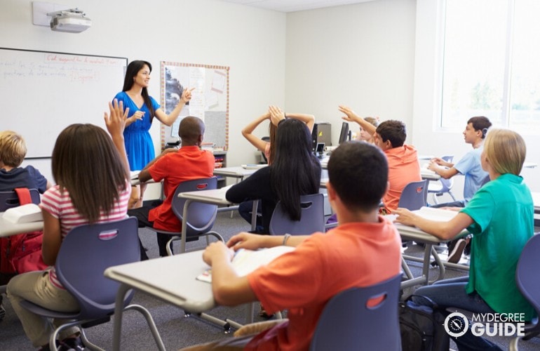 high school teacher teaching her students in class