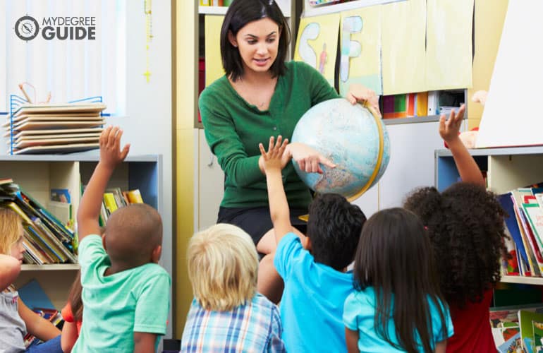 primary school teacher teaching kids