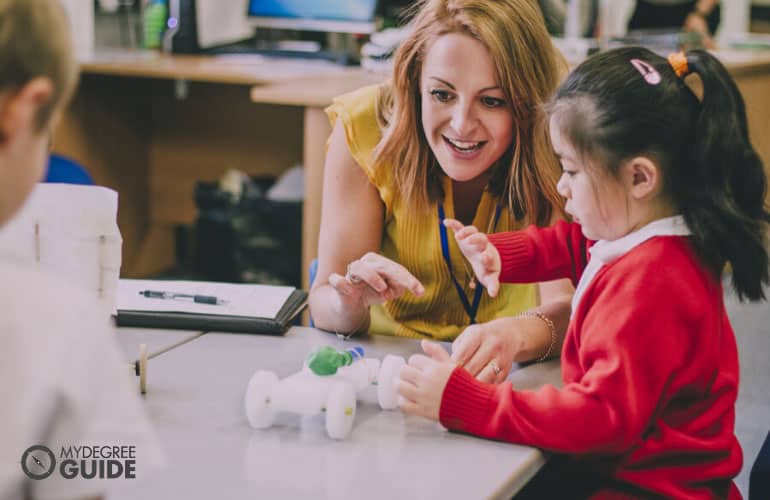 female teacher teaching a child