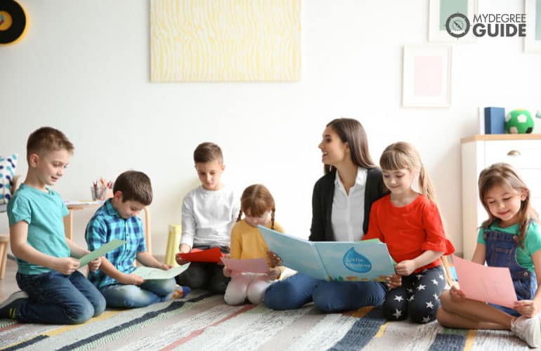 a female teacher teaching elementary students