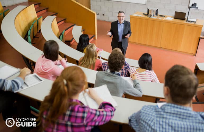 male college professor discussing in class