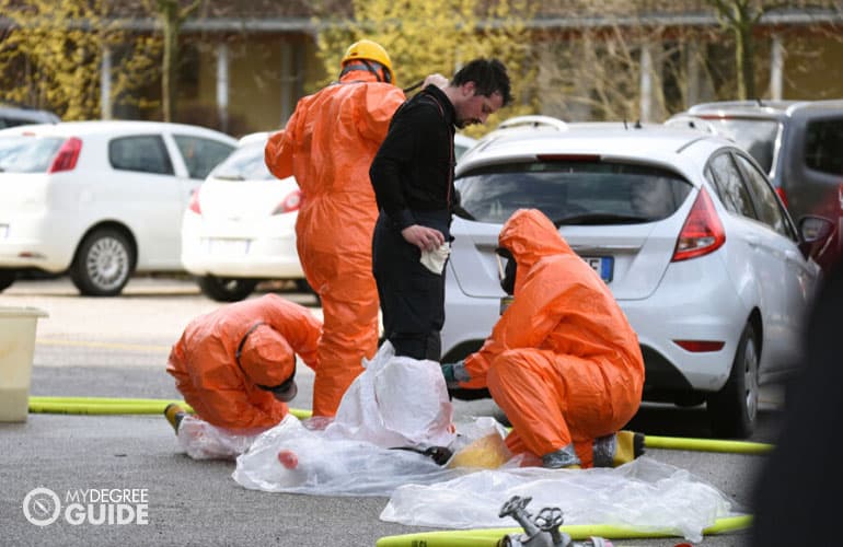 infectious disease control team sanitizing a man carrying a virus