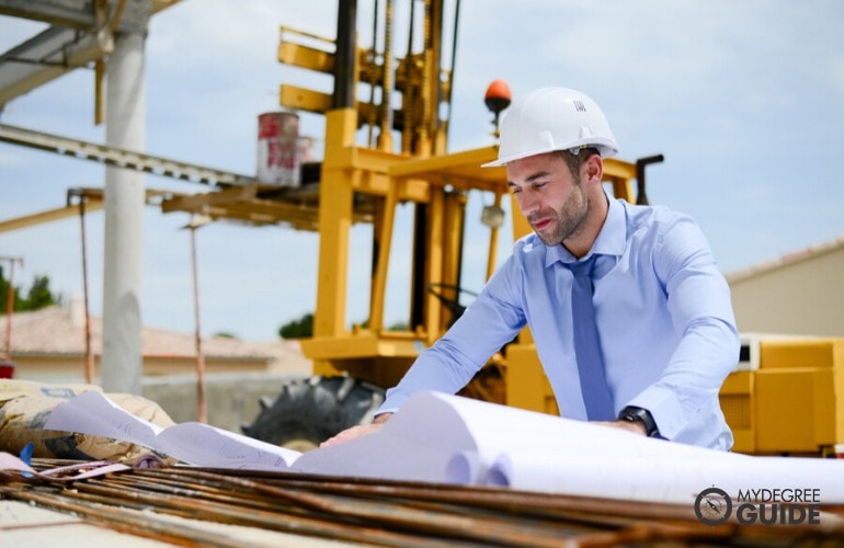 Engineering Project Manager looking at the project's blueprint