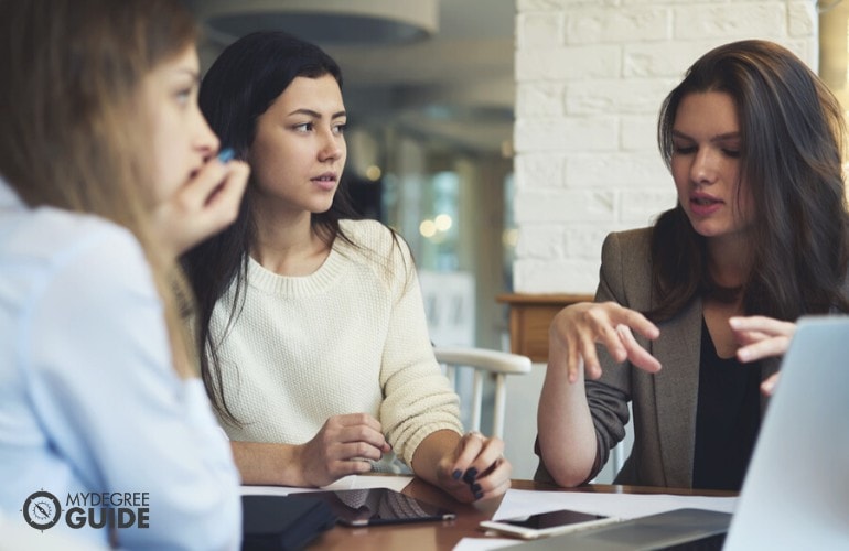 marketing manager sharing ideas with her staff during a meeting