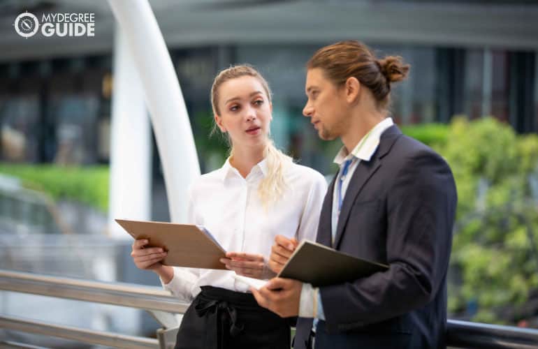 two employees discussing a project