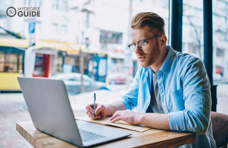 male writer working in a cafe