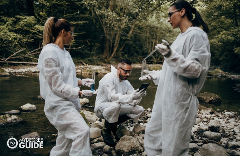 Group of hydrologists taking water samples