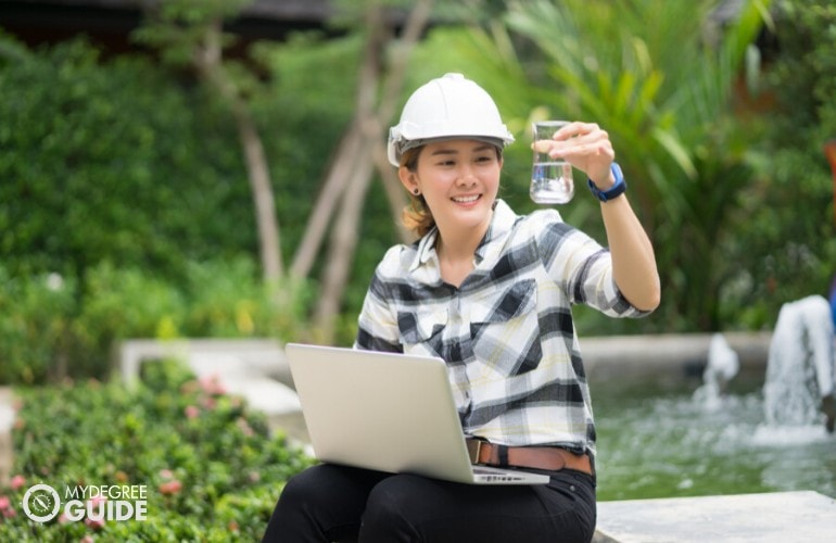 Environmental Engineer checking the water from a pond