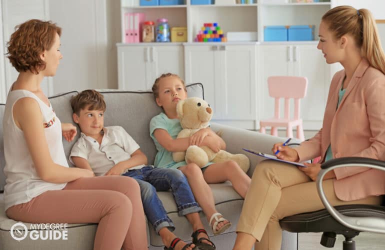 psychologist having a therapy session with a family