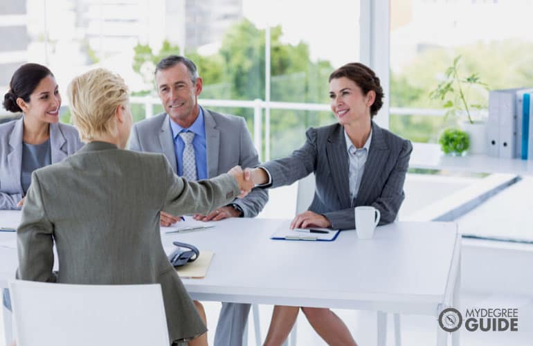 People shaking hands after an interview