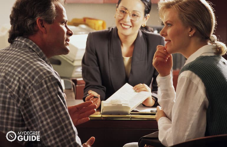 financial manager talking to a couple