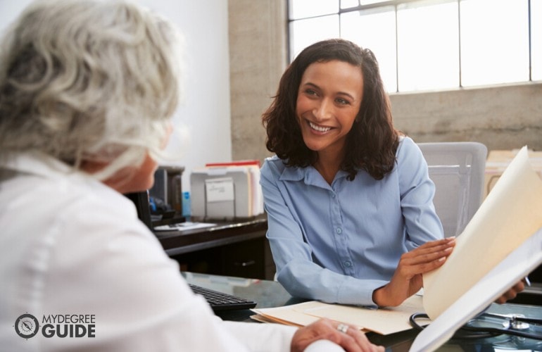 Sales agent showing documents to client