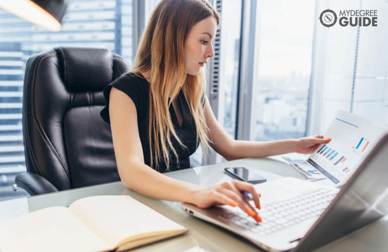 financial analyst working on her computer