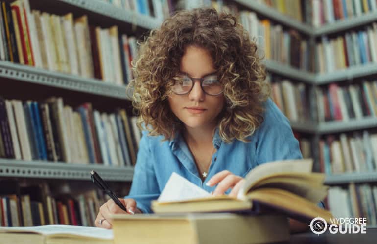 student studying in a college library