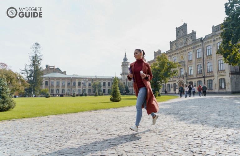 hospitality management student running across campus