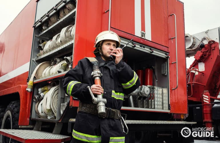 firefighter getting ready near a fire truck