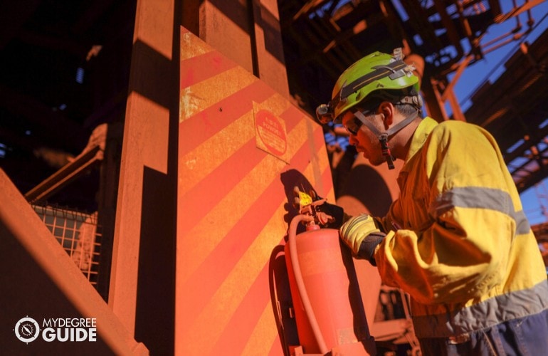 fire inspector checking the fire extinguisher