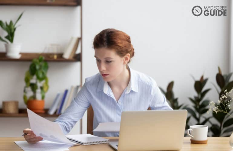 forensic accountant reviewing some documents in her office