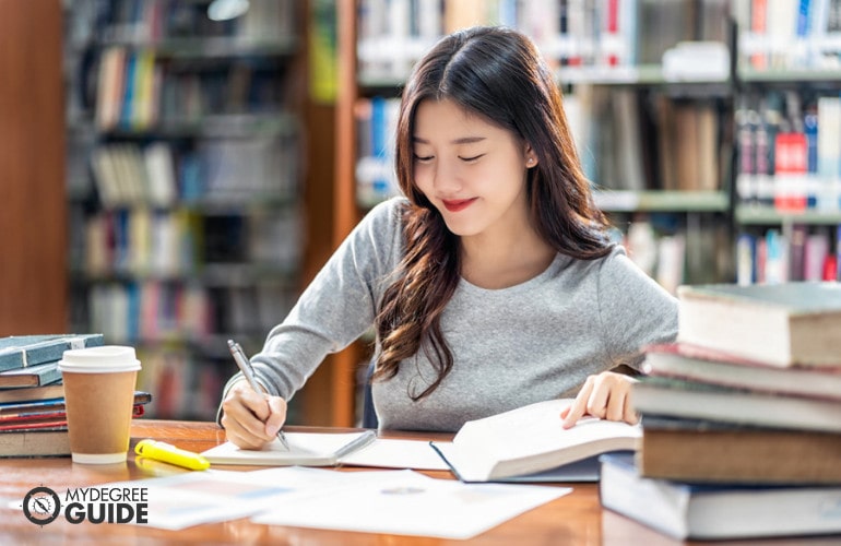 Forensic Psychology student studying in library