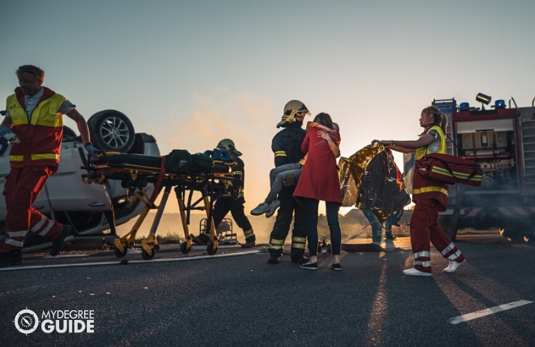 firefighters helping people in an accident