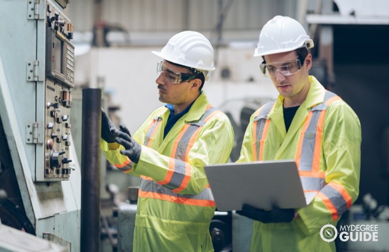 Industrial Engineers checking a machine in a plant