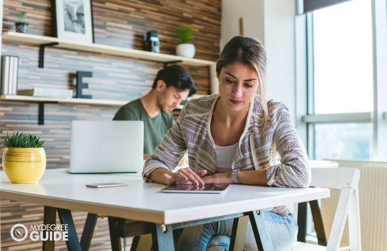 PhD in Applied Behavior Analysis Degree student researching online in a cafe