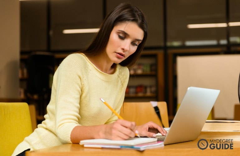 Bachelors in Mechanical Engineering student studying on her laptop