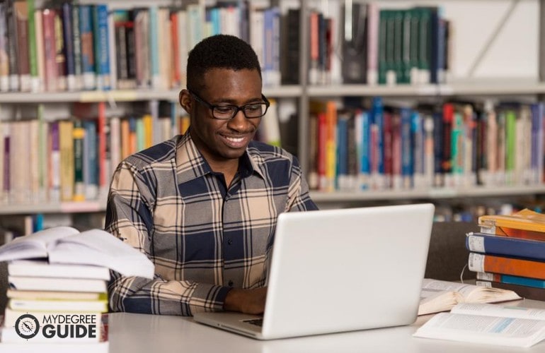 Bachelor’s in Computer Engineering student studying online in a library