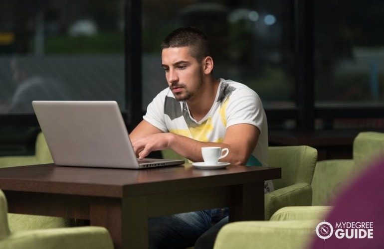 Bachelor’s in Social Work Degree student studying at a cafe