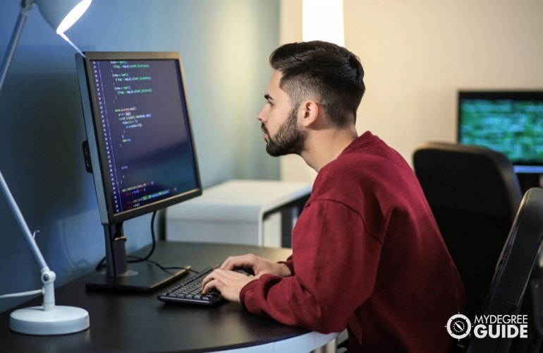 software developer working on his laptop