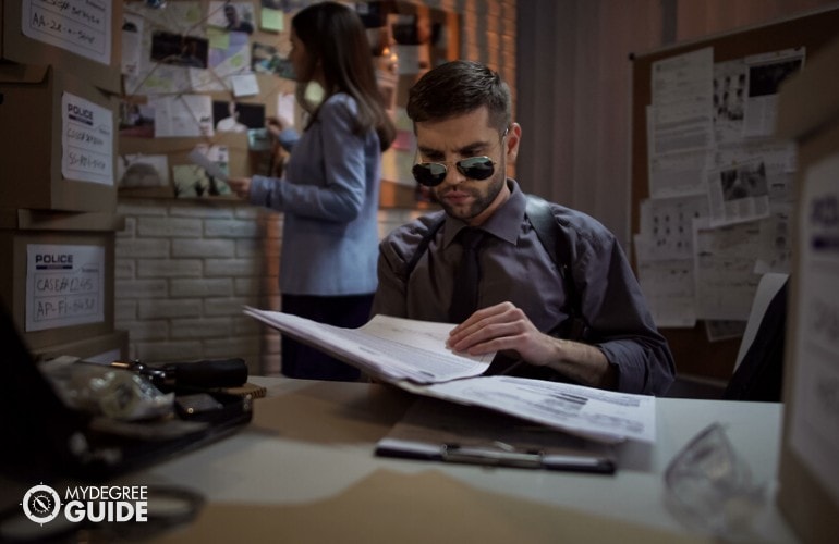 police detective checking files in office