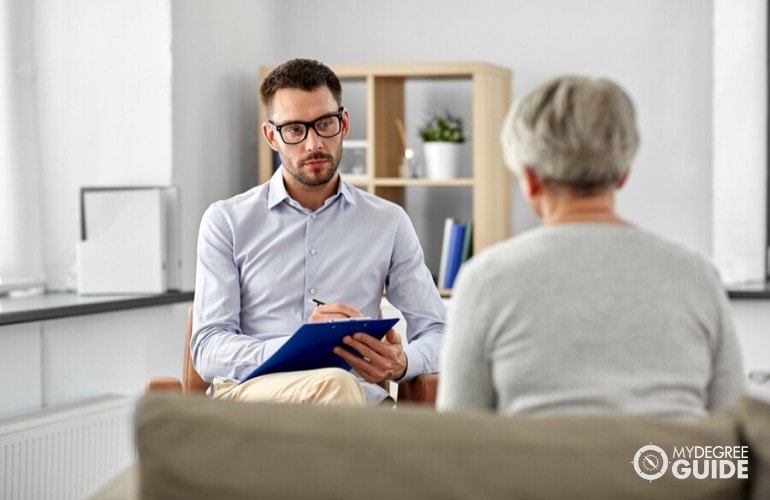 psychologist talking to a patient in his office