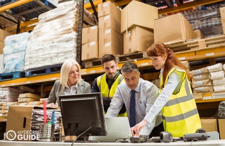 warehouse manager working on laptop