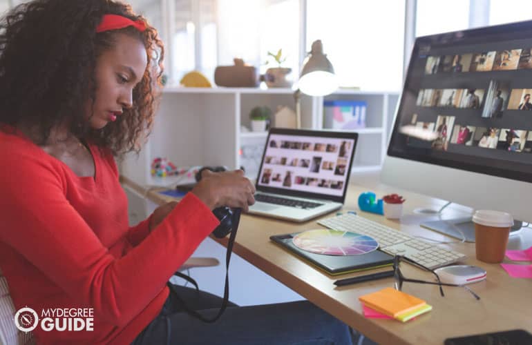 graphic designer checking images on her camera