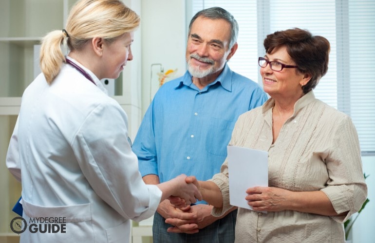 health and human services professional talking to senior couple