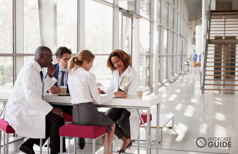 healthcare consultants meeting in a hospital cafeteria