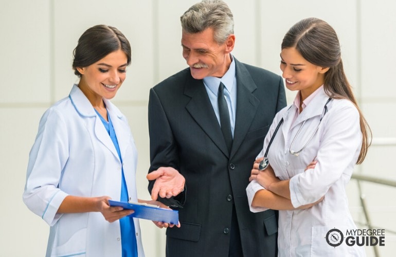 Healthcare Administrator talking to doctors in a hospital