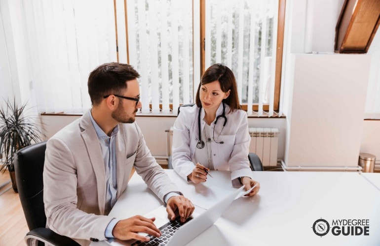 doctor an her manager working in the office