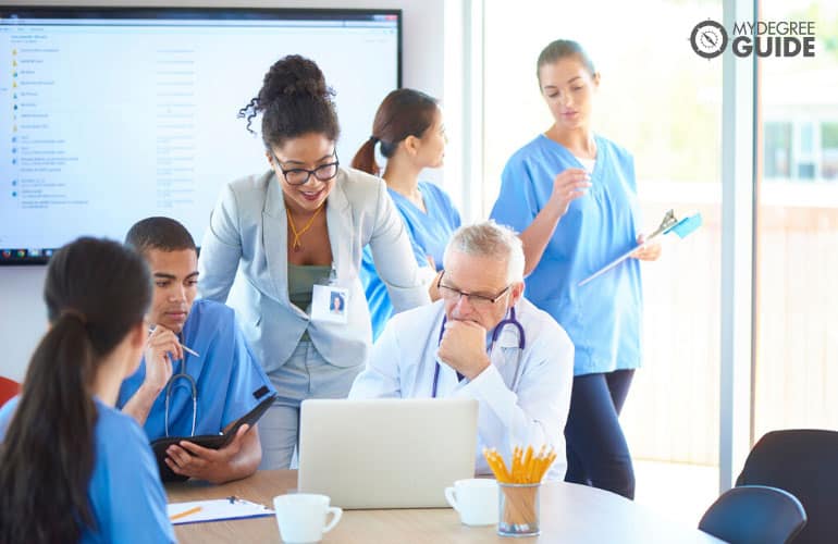 healthcare administrator talking to doctors in a hospital