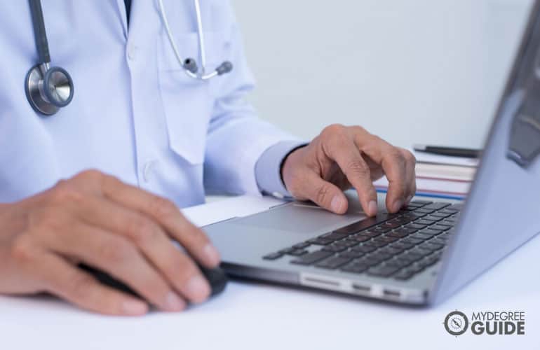 healthcare administrator working on his laptop