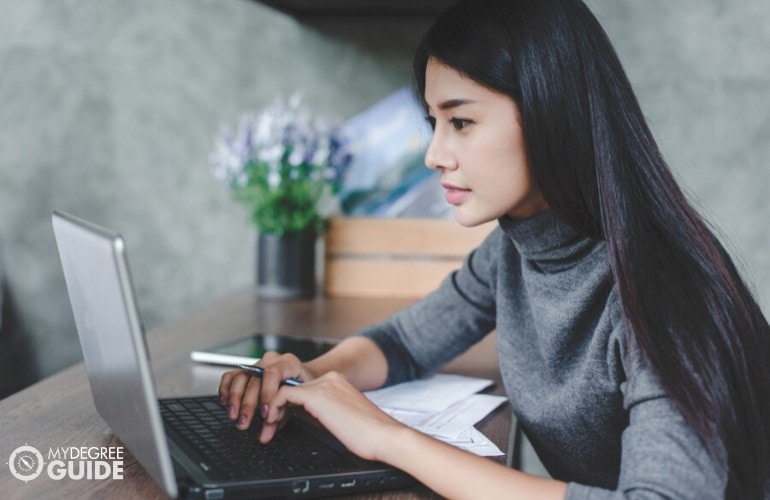 healthcare administrator studying on her laptop