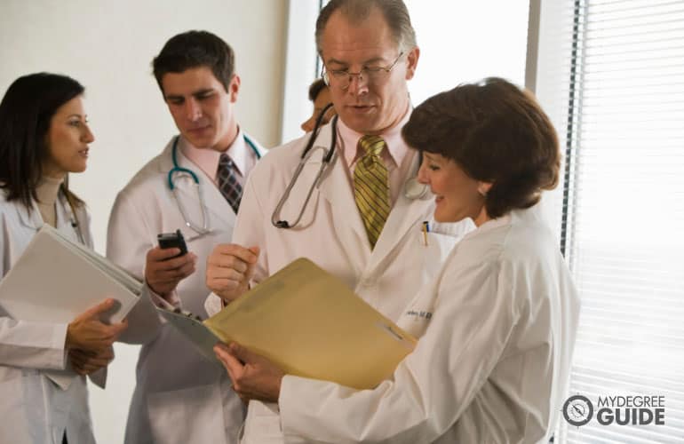 healthcare manager talking to fellow healthcare professionals