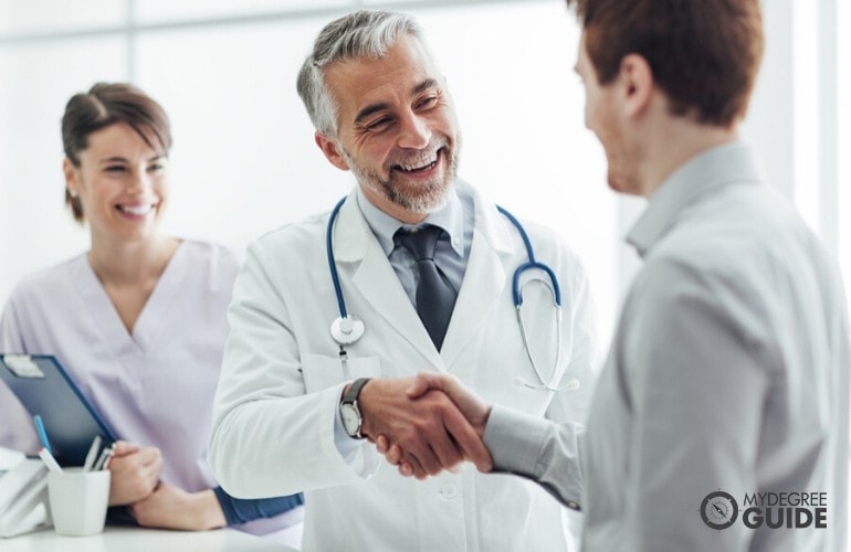 hospital administrator greeting doctors in hospital